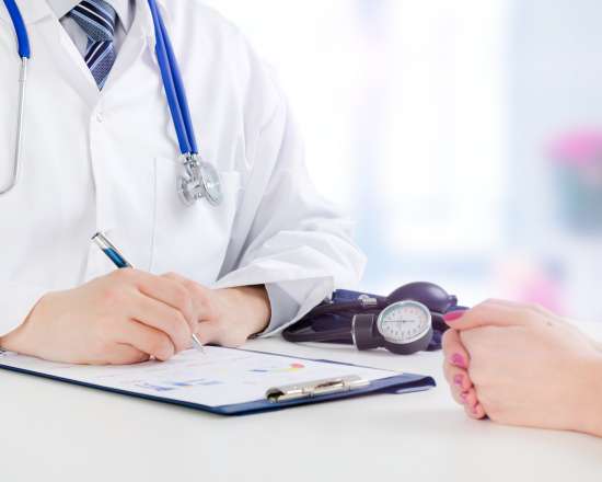 doctor and patient filling out paper work